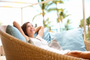 Woman relaxing in a wicker chair