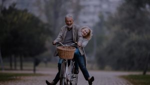 Couple riding a bicycle and laughing