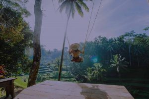 Woman swinging in a tropical climate